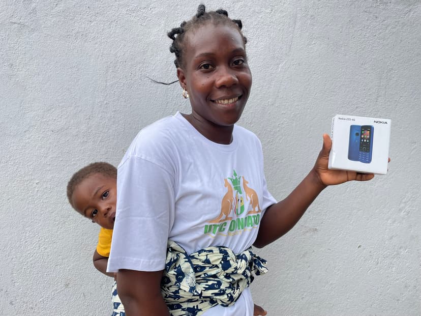 Mother with child holding mobile device